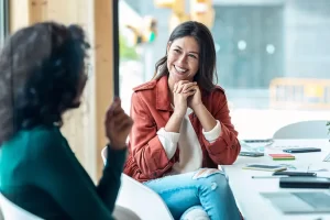 Two women. One is a life coach speaking to her client.